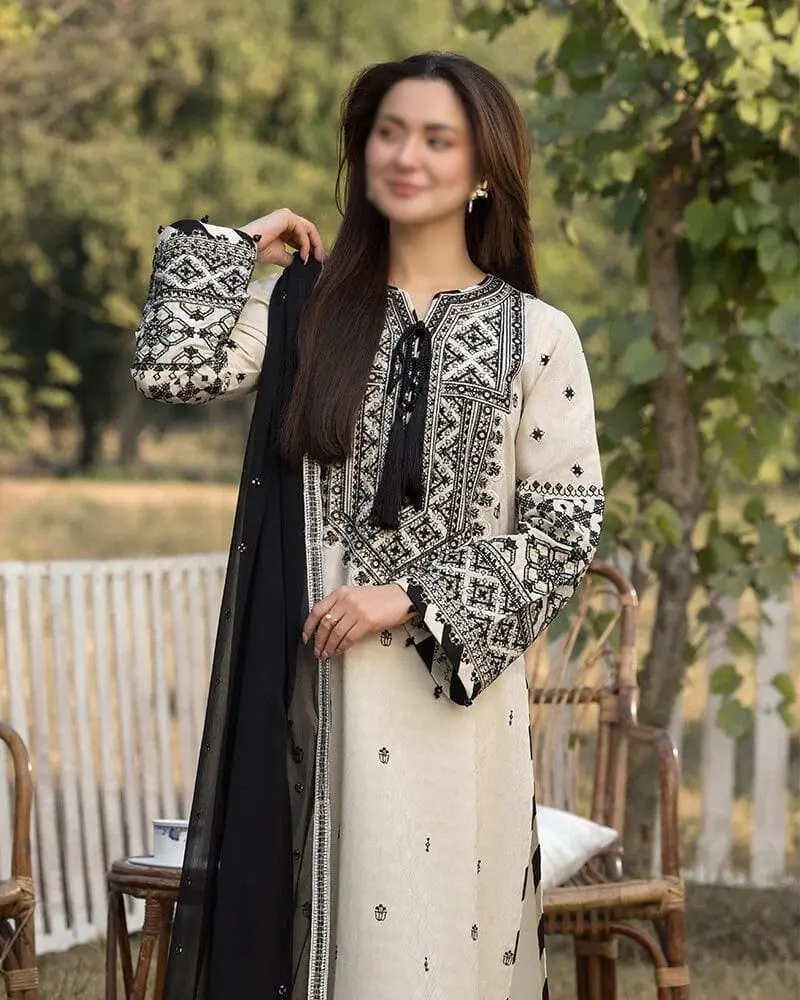 Elegant embroidered cambric cotton suit paired with a heavy chiffon dupatta – detailed neckline and soft fabric texture displayed