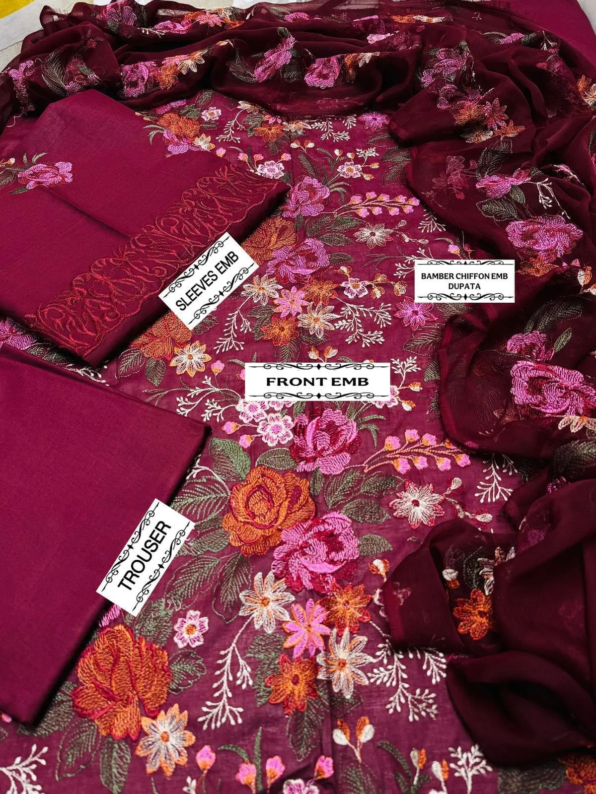 Flat lay of Bareeze maroon embroidered lawn suit showing floral embroidered front, embroidered sleeves, chiffon dupatta, and dyed trouser