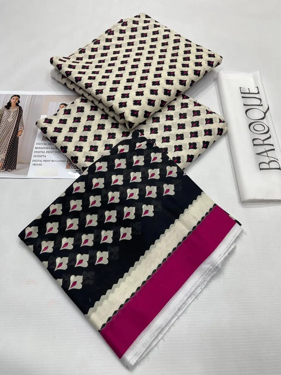 Closeup view of digitally printed shirt, trouser, and black dupatta with maroon floral accents.