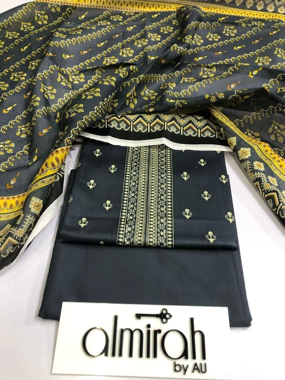 Almirah Design 01 – Black Printed Lawn Suit with Voil Dupatta and Dyed Trousers