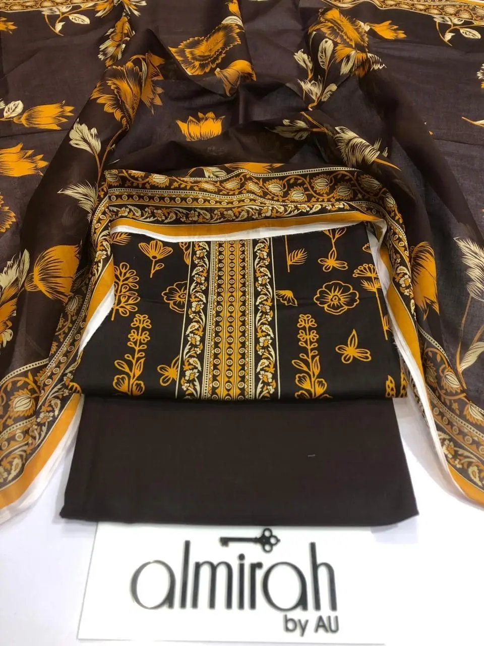 Almirah Design 04 – Dark Brown Printed Lawn Suit with Voil Dupatta and Dyed Trousers
