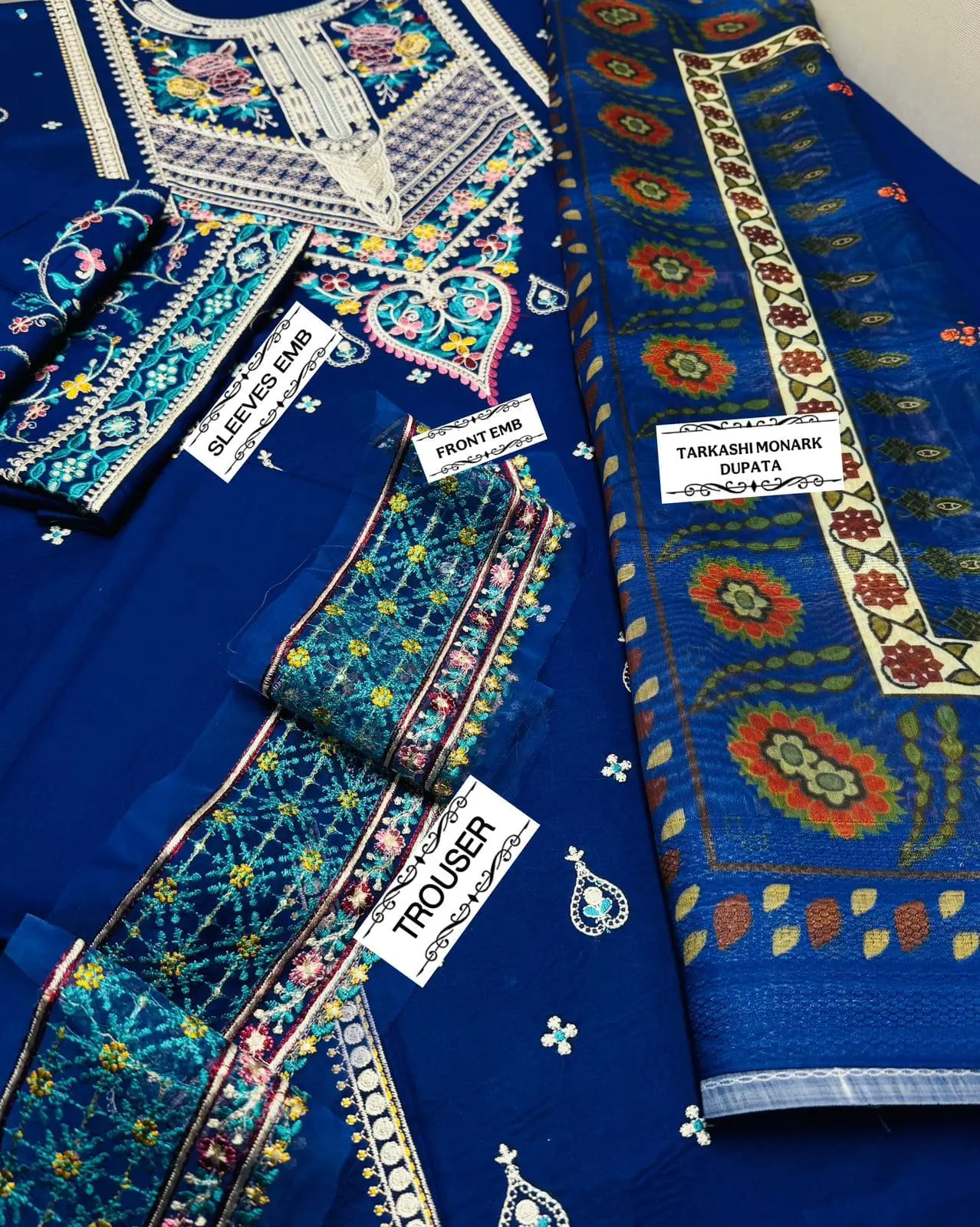 Flat lay of COCO by Zara.J blue embroidered 3pc lawn suit with front, sleeves embroidery and Tarkashi Monark dupatta