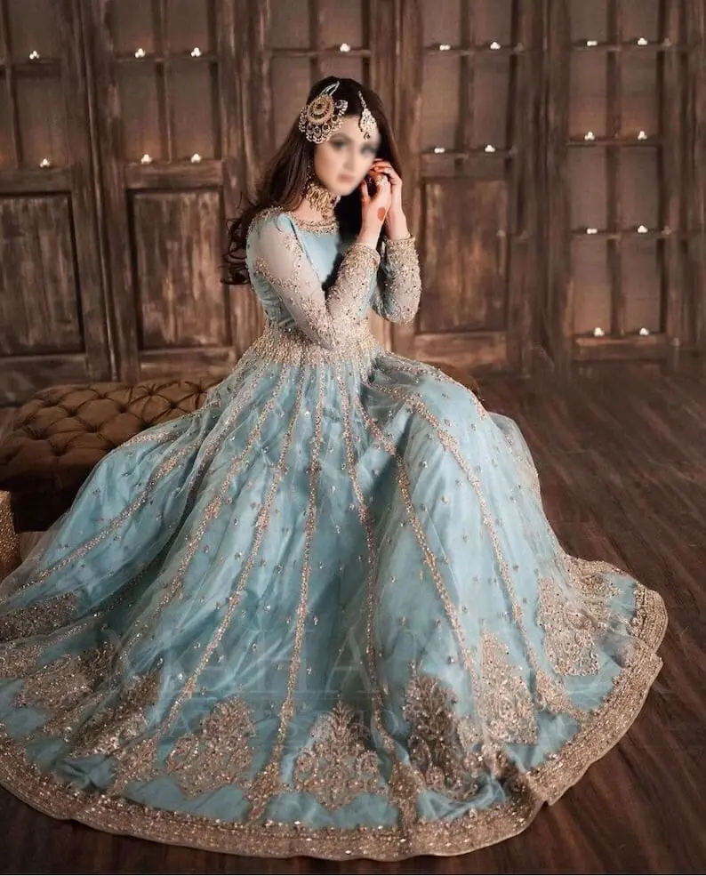 Model wearing Hira Mani inspired blush sky blue net frock with intricate embroidery and mirror work