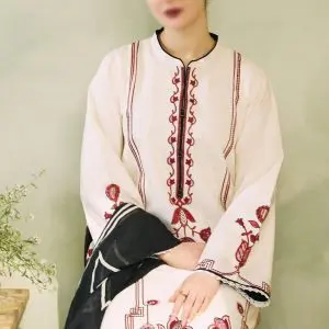 Close-up of model in Zara Shahjahan white embroidered lawn suit with red threadwork and black dupatta.